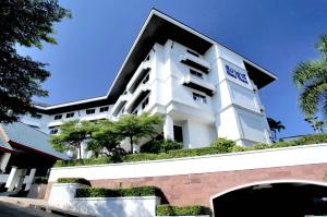 a large white building with trees in front of it at Sima Thani Hotel in Nakhon Ratchasima