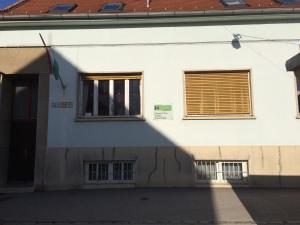 a building with a shadow on the side of it at Kolpingház Pécs in Pécs