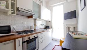 a kitchen with a microwave and a stove top oven at Italianway-Alzaia Naviglio Pavese in Milan
