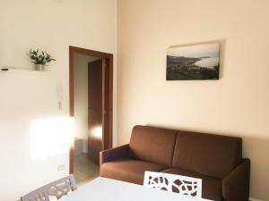 sala de estar con sofá marrón y espejo en Appartamenti Droro, en Stella Cilento