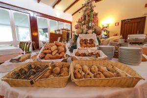 a table with three baskets of pastries on it at Hotel Apartamento Do Golfe in Vilamoura