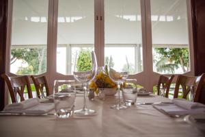 a table with wine glasses on top of it at Hotel Apartamento Do Golfe in Vilamoura