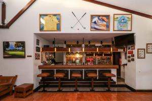 a bar with a clock on the wall at Hotel Apartamento Do Golfe in Vilamoura