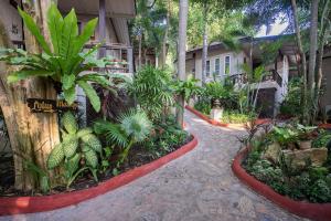 a garden in front of a building with plants at Samed Villa Resort in Ko Samed