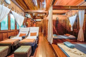 a train car with chairs and windows in it at Samed Villa Resort in Ko Samed
