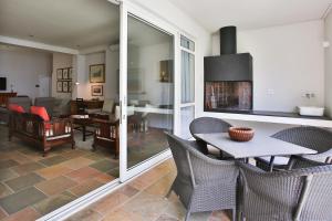 a dining room and living room with a table and chairs at Laanhof Victorian House Self-Catering in Stellenbosch