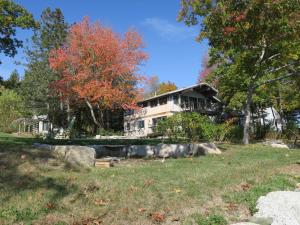 a house in the middle of a field at Acadia Ocean Front Garden Cottages in Trenton