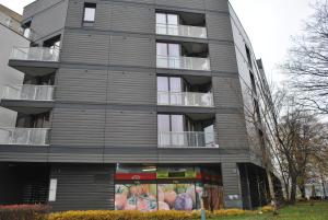 an apartment building with a mural on the side of it at Pirelli Apartament in Warsaw
