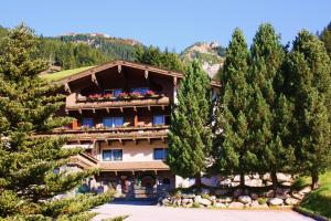 a large building with trees in front of it at Pension Marina in Tux