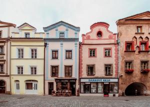 a group of buildings on a street in a city at Penzion Víno Hruška Pardubice in Pardubice