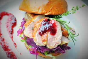 a sandwich with meat and vegetables on a plate at APARTMÁNY RYBNÍČEK in Staré Město +26 photos