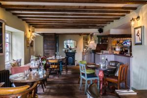 a restaurant with tables and chairs and a fireplace at The Bell & Stuart House in Stow on the Wold