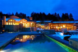a house with a swimming pool at night at Topnotch Resort in Stowe