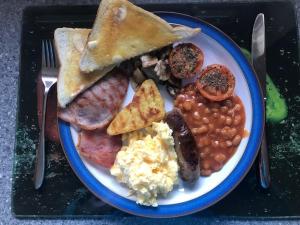 a plate of breakfast food with eggs beans and toast at Babbling Brook Guesthouse in Keswick