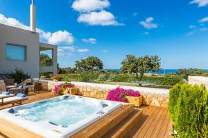 a hot tub on the deck of a house at Villa Victoria - A Private Family Gem in Gállos