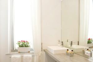 a bathroom with two sinks and a mirror at B&B Albaro in Genoa