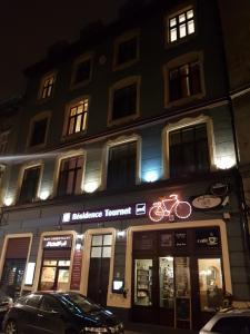 a building with a bike sign on the front of it at Résidence Tournet in Krakow