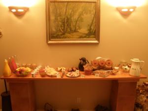 a table with a bunch of items on it at Cedar Wood Lodge Bed & Breakfast Inn in Port Alberni