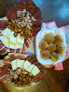 a table with two plates of food with bread and cheese at Nađ Holiday Home in Privlaka