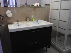 a bathroom with a white sink and a shower at Las Flores studio 3 in Playa de las Americas