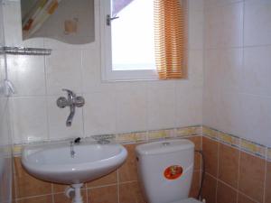 a bathroom with a toilet and a sink and a window at Jafura in Dolná Turecká