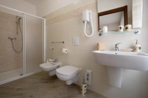 a bathroom with a sink and a toilet and a shower at I Colli del Garda in Lonato +23 photos