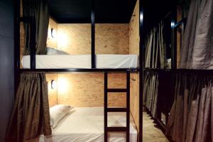 two bunk beds with a ladder in a room at KID Hualien Hostel in Hualien City