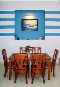 a dining room with a wooden table and chairs at Hana Homestay Danang in Da Nang +39 photos