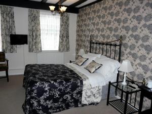 a bedroom with a black and white bed and a window at The Croft in Bridgnorth