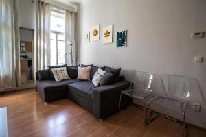 a living room with a couch and two glass tables at Modern Cozy Apartment by Ruterra in Prague