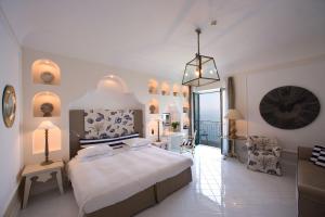 a bedroom with a large bed and a balcony at Bellevue Syrene in Sorrento