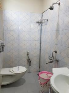 a bathroom with a toilet and a sink at Hotel Sitara Residency in Hyderabad +24 photos