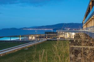 a view of a building with the ocean in the background at Pedras do Mar Resort & Spa in Fenais da Luz