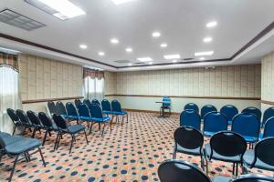 a conference room with blue chairs and a table at Days Inn & Suites by Wyndham Fort Pierce I-95 in Fort Pierce +21 photos