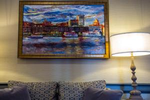 a living room with a painting on the wall at East Bay Inn, Historic Inns of Savannah Collection in Savannah