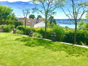 a yard with green grass and two lights on it at Lakescape Zurich in Herrliberg