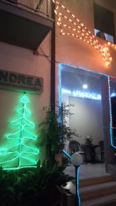 a christmas tree on the side of a building with lights at Pensione Andrea in Chianciano Terme
