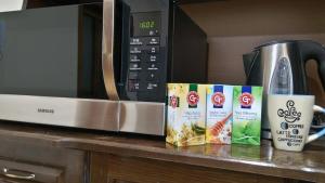 a counter with a microwave and two boxes of food at Guest House Fun and Rest in Plovdiv