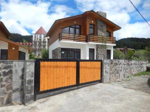 a house with a gate in front of it at Cottage Sunny Side in Bakuriani