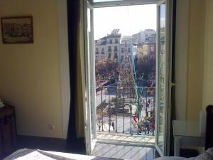 a view of a christmas tree from an open window at Casa Palacio López Daza in Granada