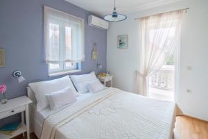 a bedroom with a white bed and a window at Holiday home Privlaka/Zadar Riviera 8218 in Batalaži