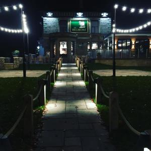 a walkway in front of a building at night at The Belmore in Sale