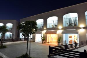 a building with a courtyard at night at Nicotel Ostuni in Carovigno