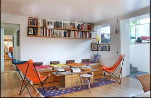 a living room with a couch and a table and chairs at Hameau des artistes in Paris