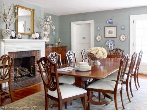 a dining room with a table and chairs and a fireplace at Stagecoach Inn in Goshen