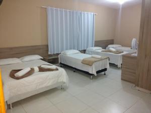 Postel nebo postele na pokoji v ubytování Conquista Palace Hotel