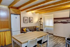 a kitchen and dining room with a table and a couch at PenicheArtHouse in Peniche