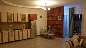 a kitchen with a refrigerator and a table and chairs at villa in mountains in Bakuriani