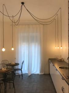 a kitchen with a white curtain and a table at Salerno M'illumina in Salerno