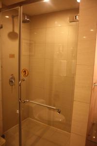 a shower with a glass door in a bathroom at Super House International in Beijing